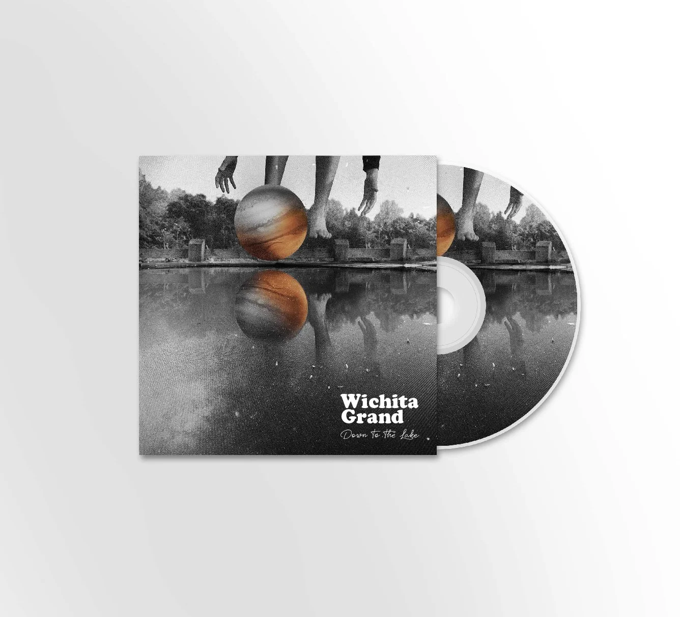 CD cover featuring a black and white photograph of a person balancing a ball on their foot, reflected in water, with text 'Wichita Grand' and 'Down to the Lake'.