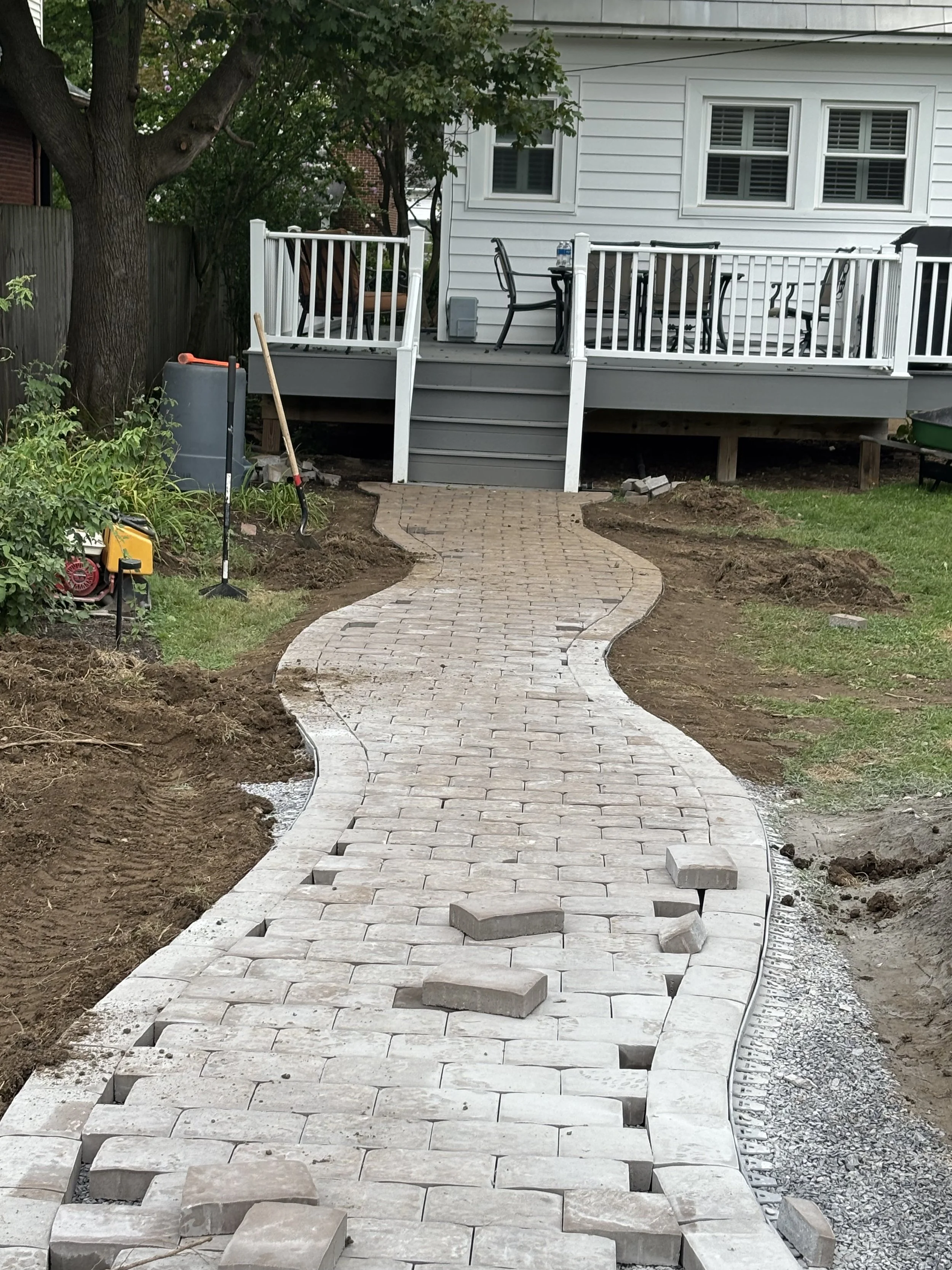 Curved brick paver walkway under construction by Miska's at a residential property in State College, Pennsylvania