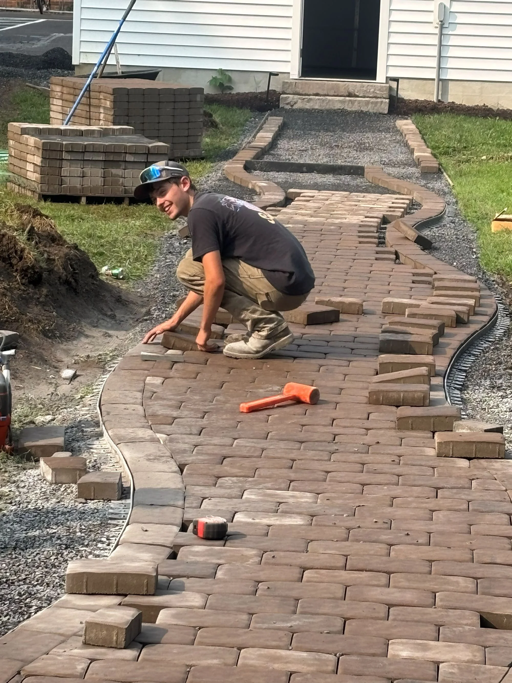 Miska's crew installing brick pavers for a residential walkway in State College, Pennsylvania