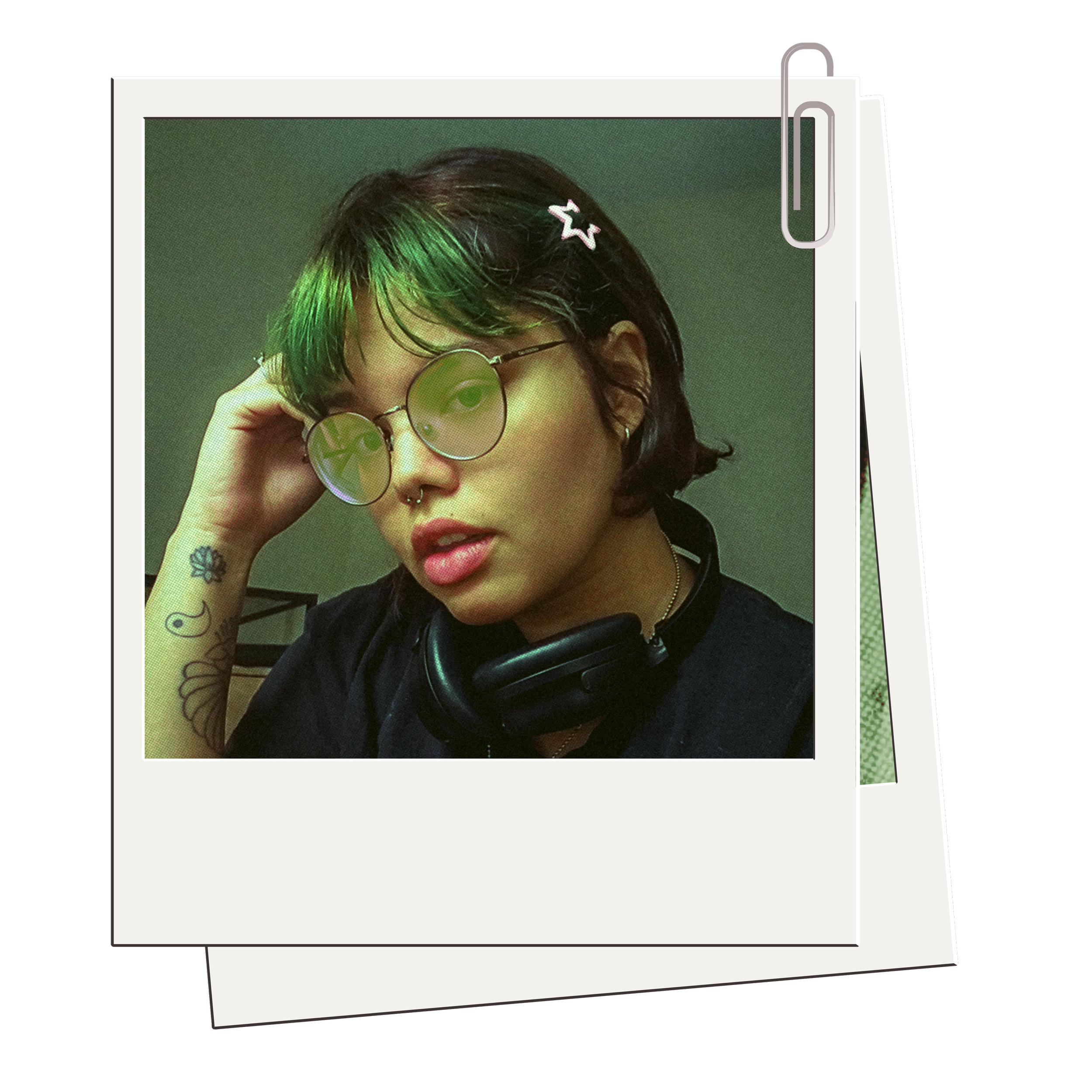 A printed portrait of a woman with dark hair, green highlights, wearing round glasses and a septum piercing, with a background of green, placed inside a digital frame with a paperclip.