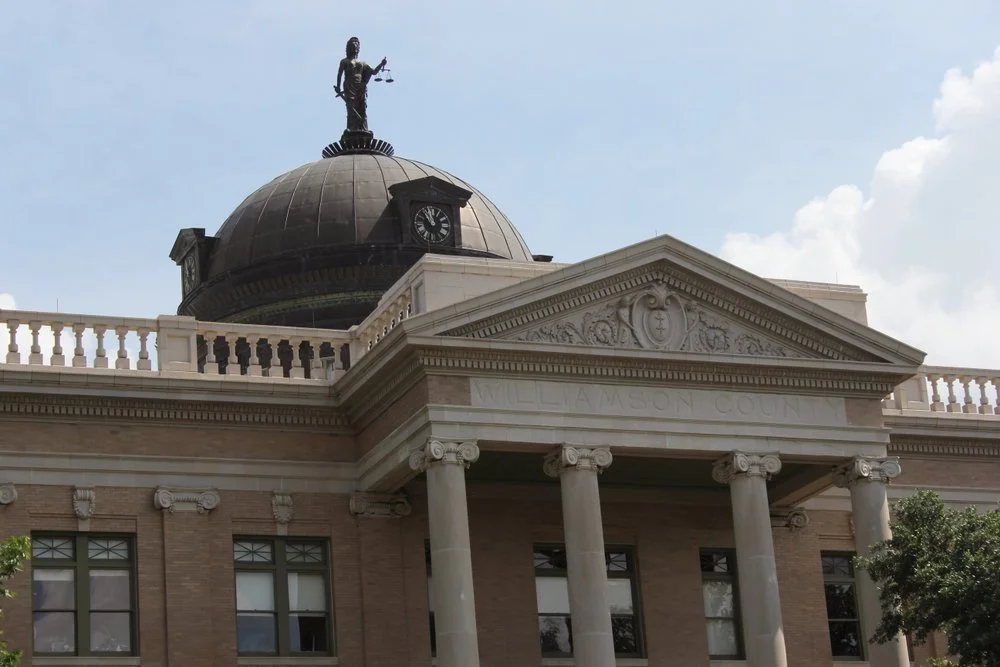 Historical government building with columns, a dome, and a statue on top, labeled 'Williamson County'.