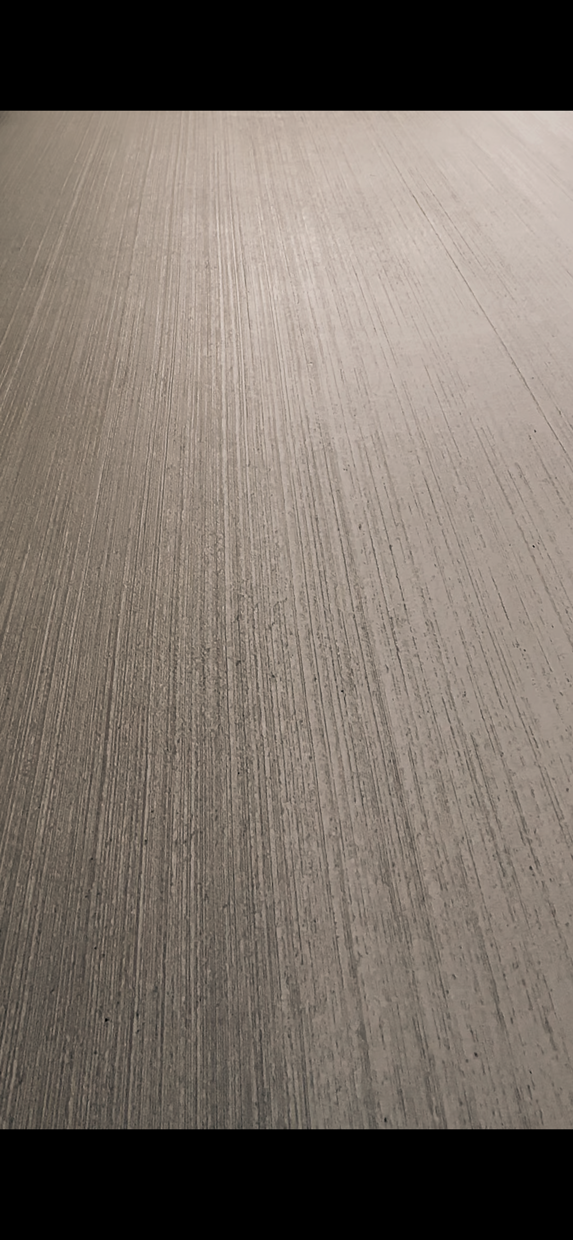 Close-up of a textured gray tabletop surface with fine vertical lines.