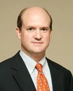 Portrait of a man in a suit and tie with a neutral background