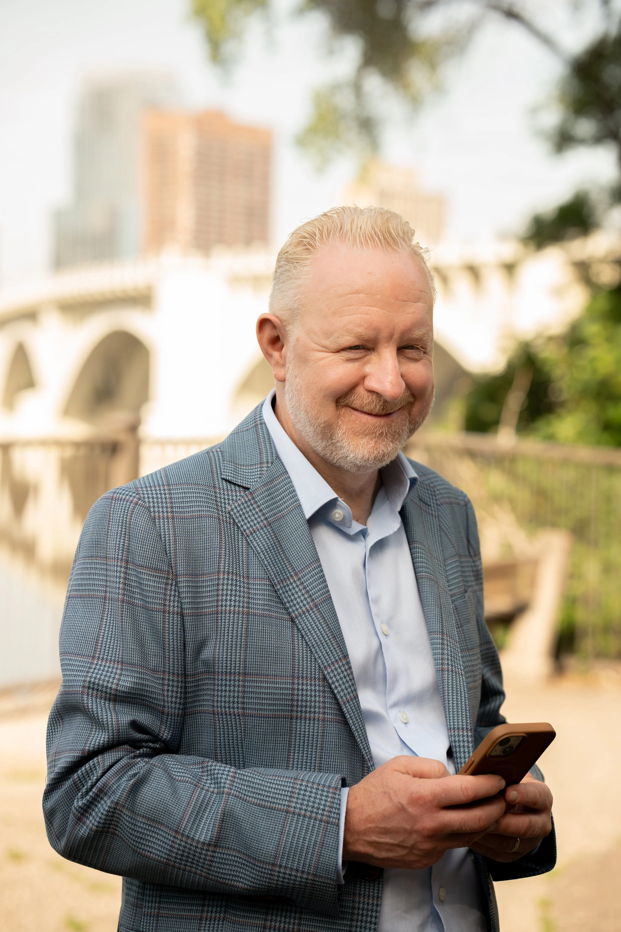 Image of Brian smiling when he receives an inquiry to connect on his phone