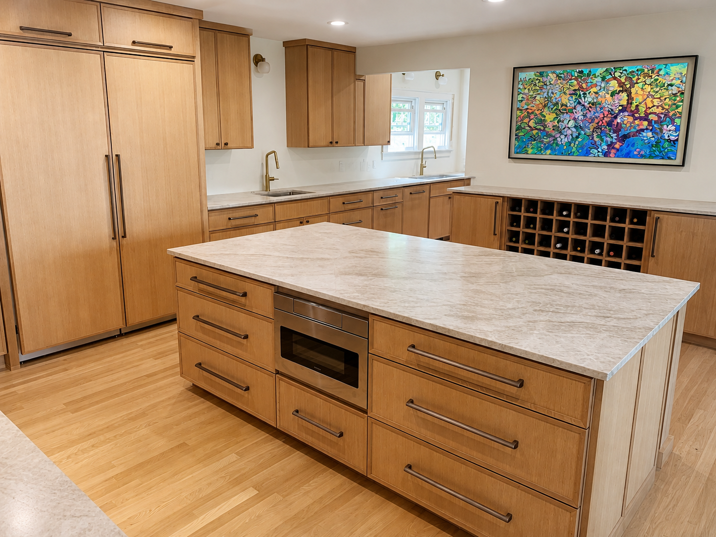 Modern kitchen with wooden cabinets, marble countertops, and a large kitchen island. Features built-in oven, two sinks with faucets, and a wall-mounted colorful painting. Includes a wine rack.
