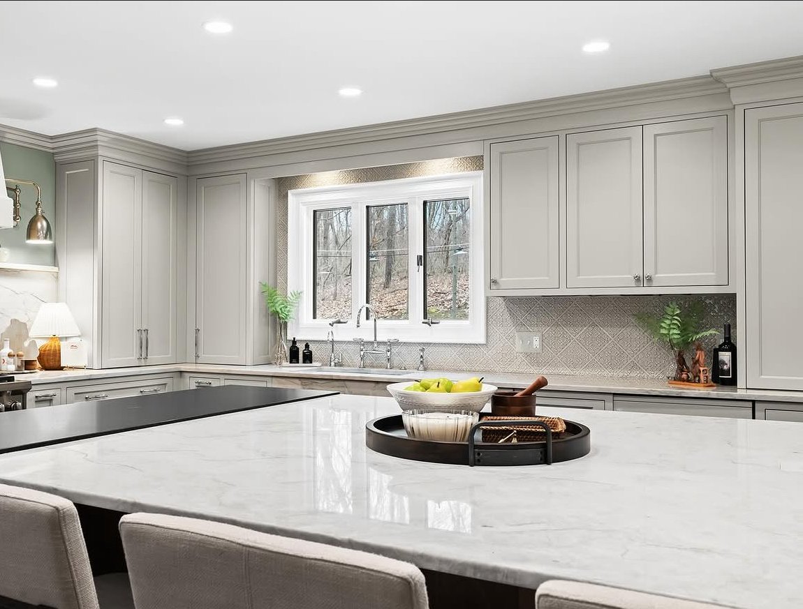 Custom white shaker kitchen with oversized quartz island in Rochester Hills, Michigan