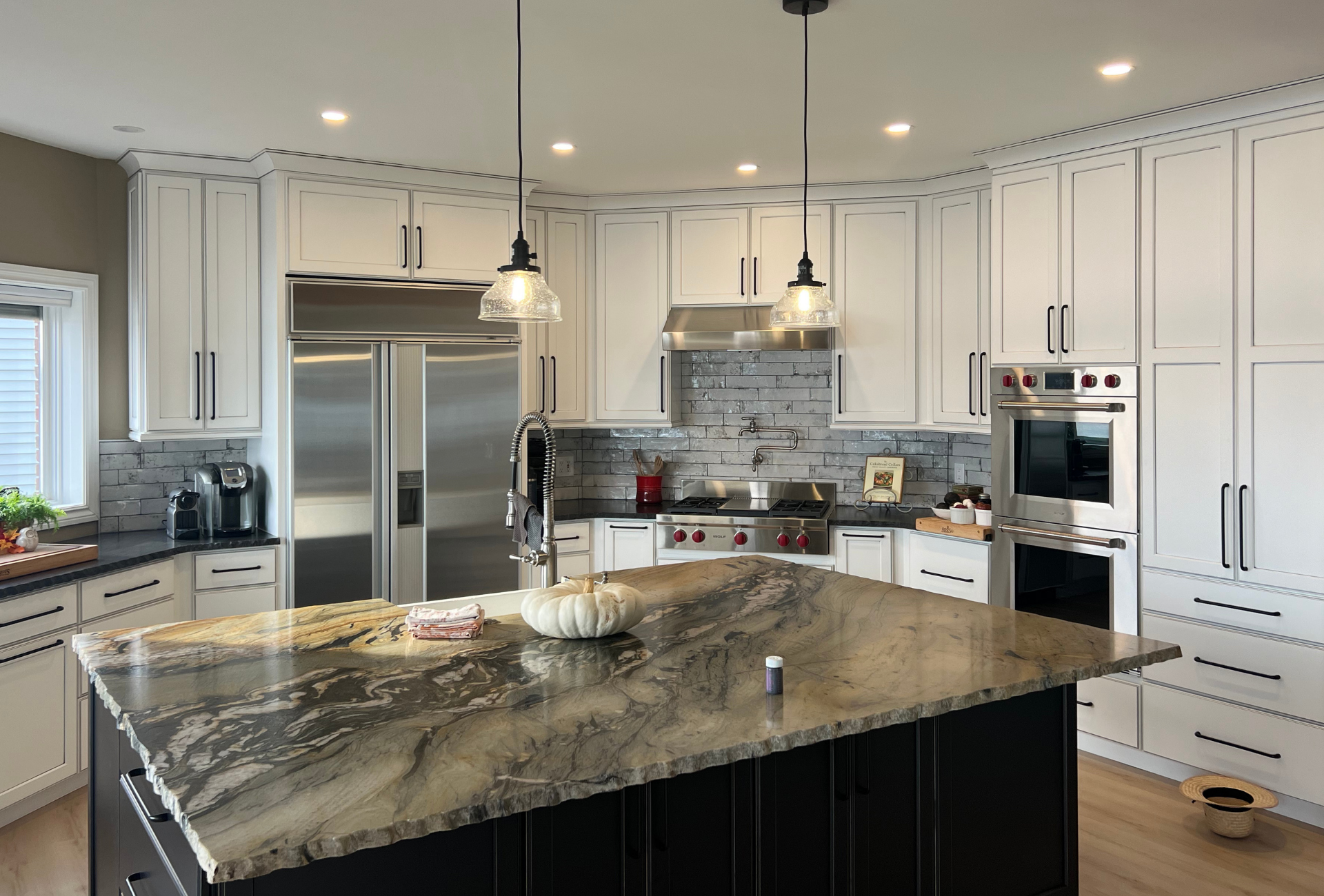 Custom kitchen cabinets in Rochester Hills, Michigan with white shaker cabinetry and granite island