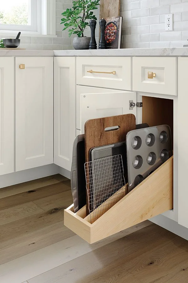 Pull-out organizer with baking sheets and cooling racks in a modern kitchen