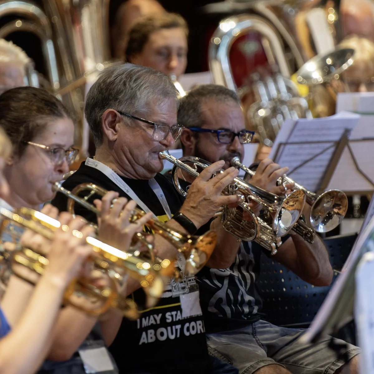A group of musicians playing trumpets during an orchestra rehearsal or performance.