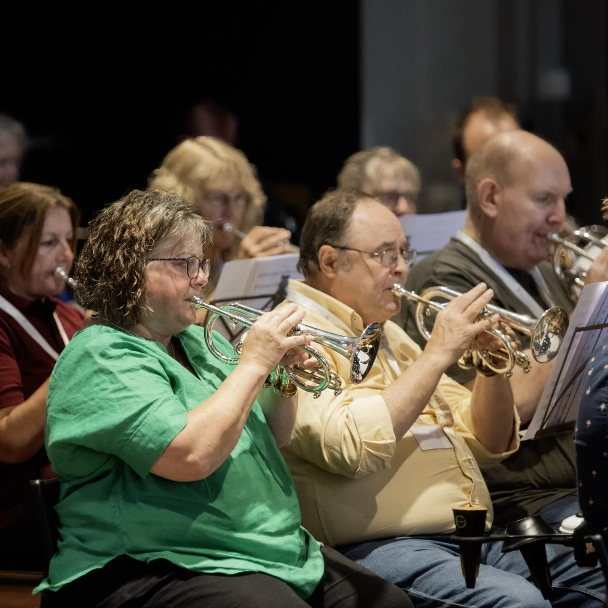 Orchestra musicians playing trumpets during a performance.