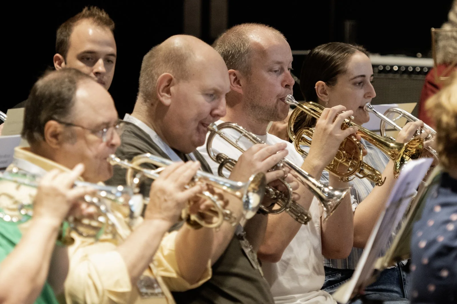 A group of musicians playing trumpets during a performance.