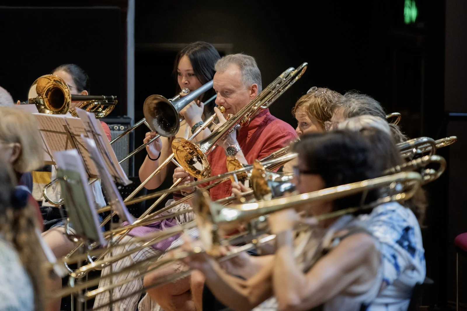 A group of musicians playing trombones in an orchestra.