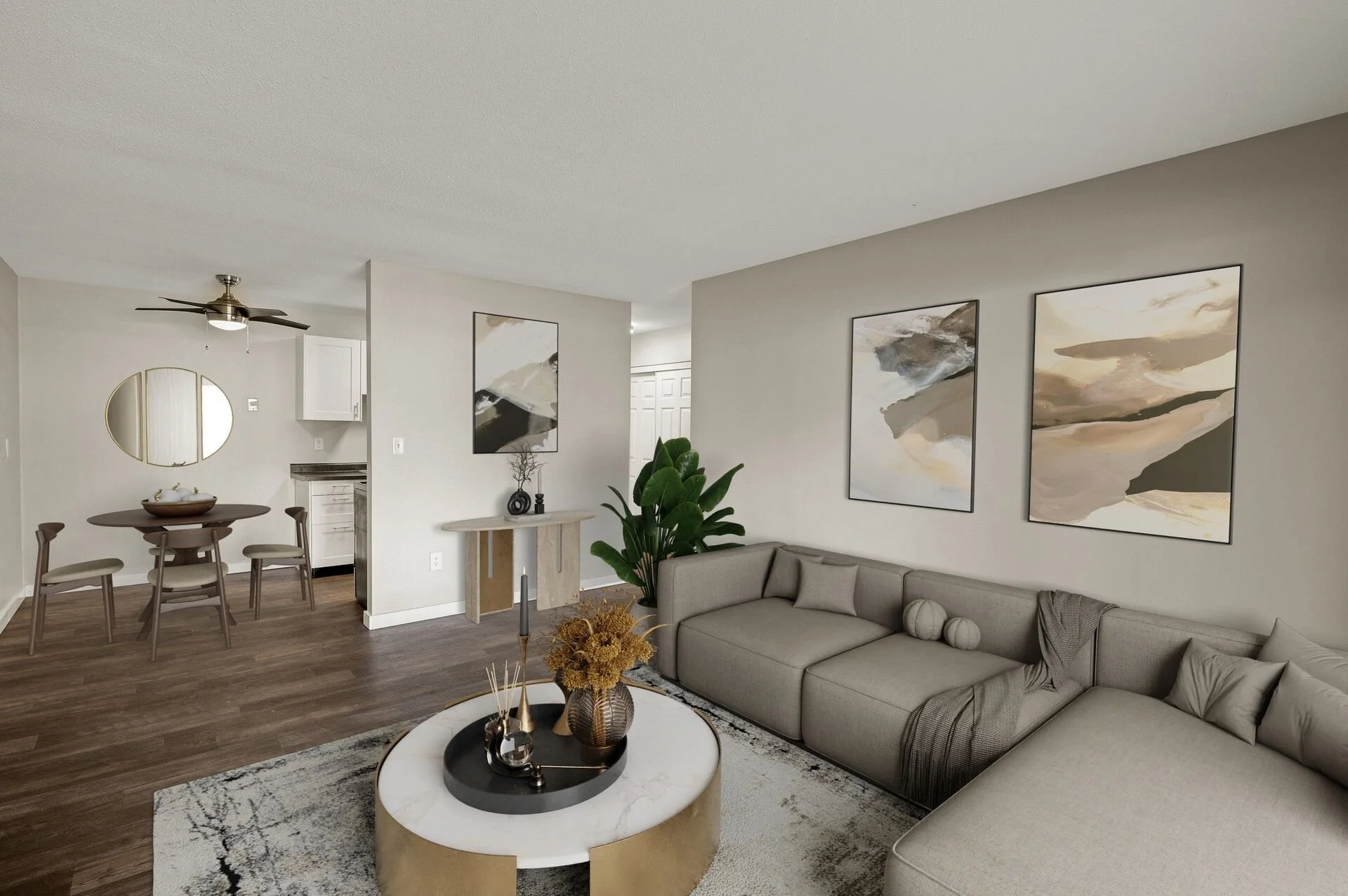 Living room with beige sectional sofa, abstract wall art, coffee table with decorative items, and wood flooring at Eastgate Apartments in White Bear Lake, MN