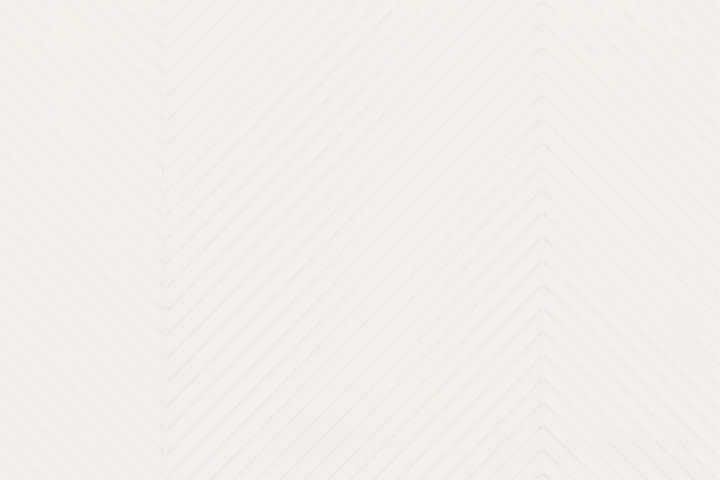 A blank white textured surface with diagonal lines creating a chevron pattern.