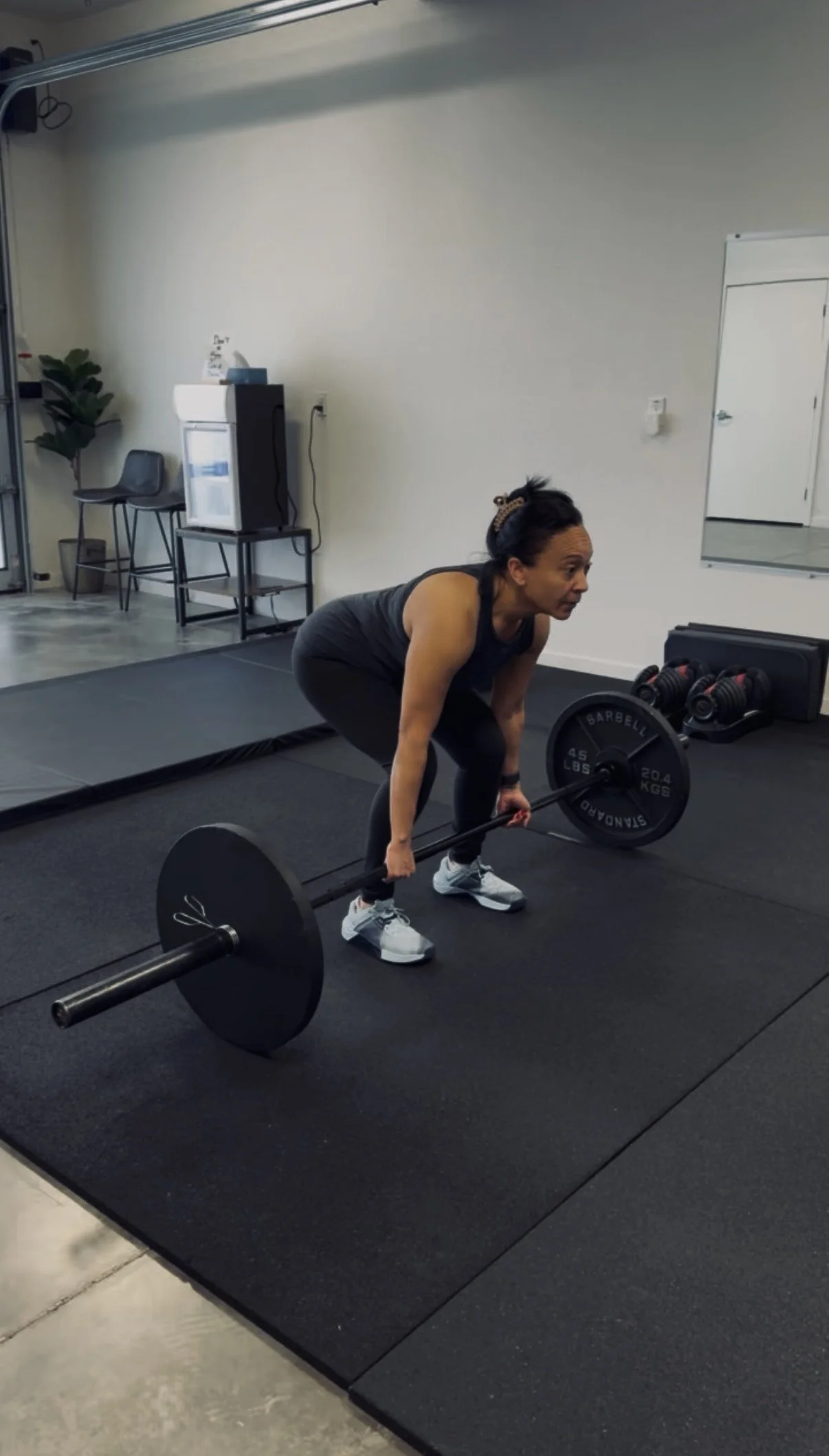 Patient performing a barbell deadlift during strength-based rehab at Ninety Four Performance & Rehab in Richmond, CA
