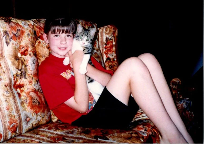 Rachel as a young girl with her tabby cat