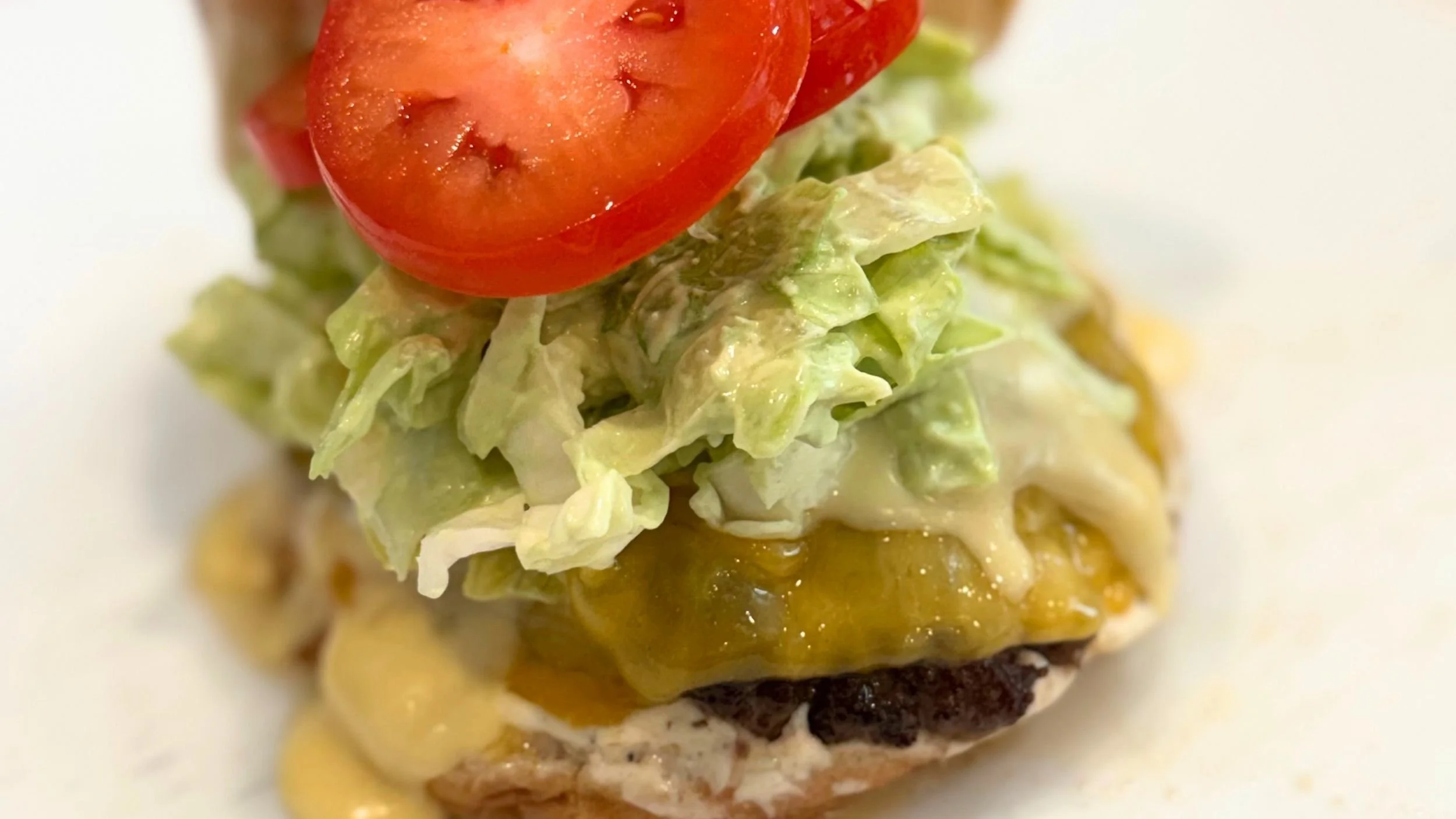 wagyu burger with tomato and lettuce and cheese