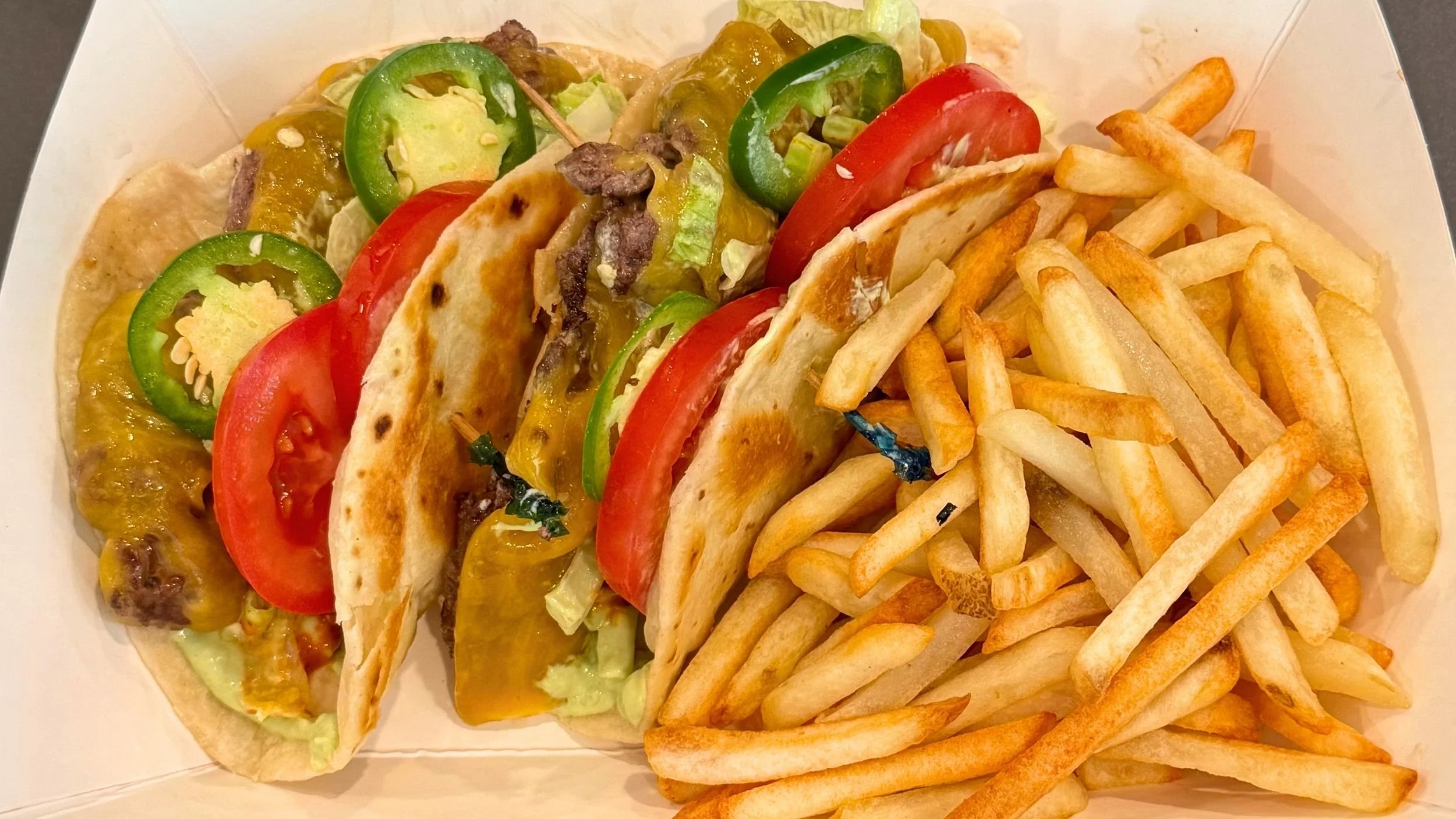 wagyu smash burger tacos with lettuce tomato, jalepenos, and fries