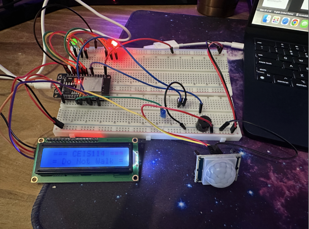 Western Edge Studios. A breadboard microcontroller project connected to an LCD display, a PIR motion sensor, and several wires, with a laptop nearby.