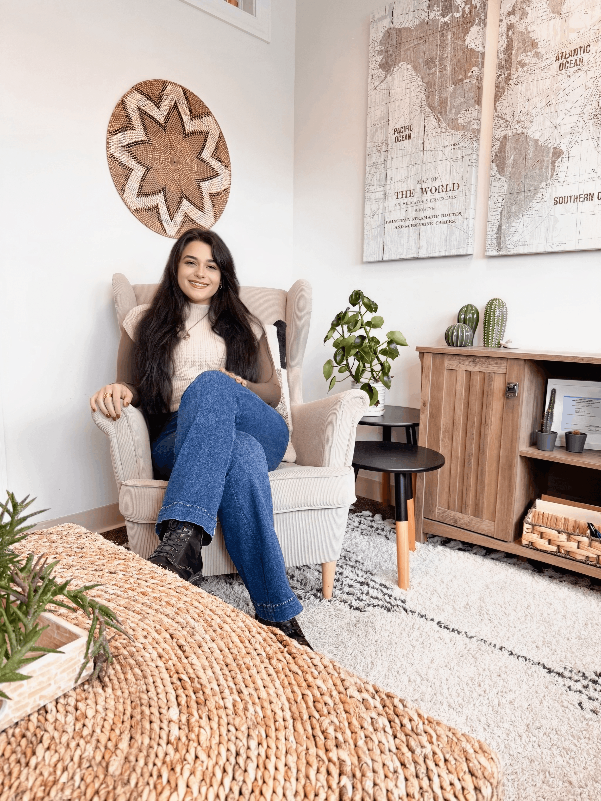 A mental health counselor seated in her modern therapy office, surrounded by minimalist décor, natural textures, and a serene atmosphere. The space highlights a professional yet approachable setting for virtual therapy in Massachusetts.