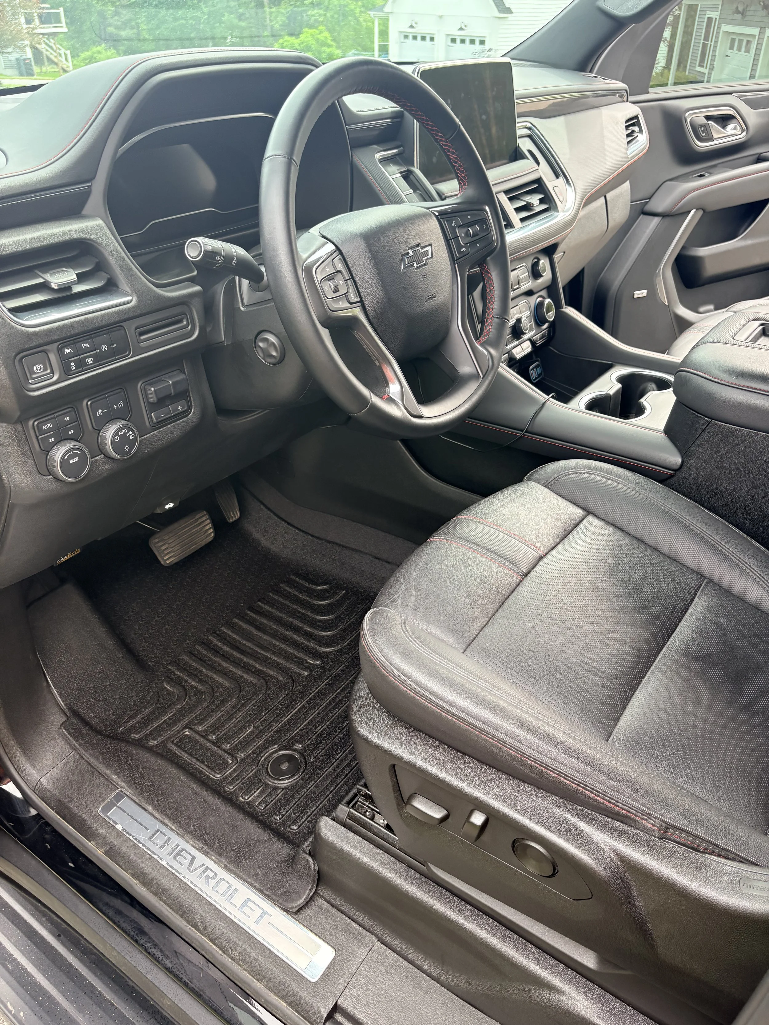 Interior of a Chevrolet Silverado truck, showing the steering wheel, dashboard, center console, and driver's seat.