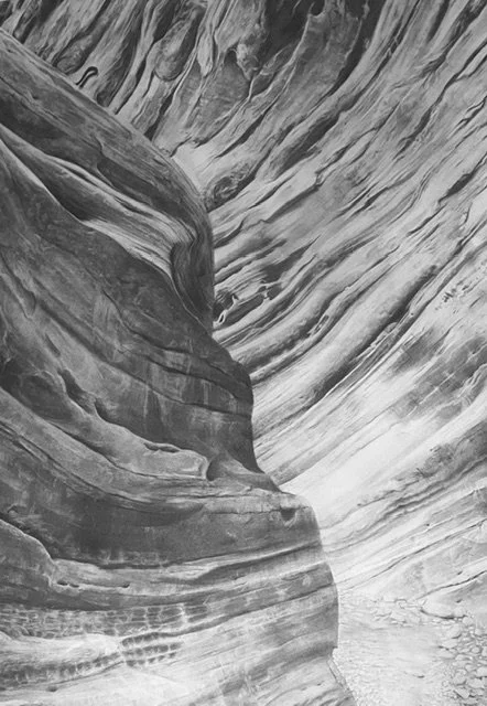 Graphite drawing of layered rock formations with smooth, wavy patterns, depicting Little Wild Horse slot canyon.