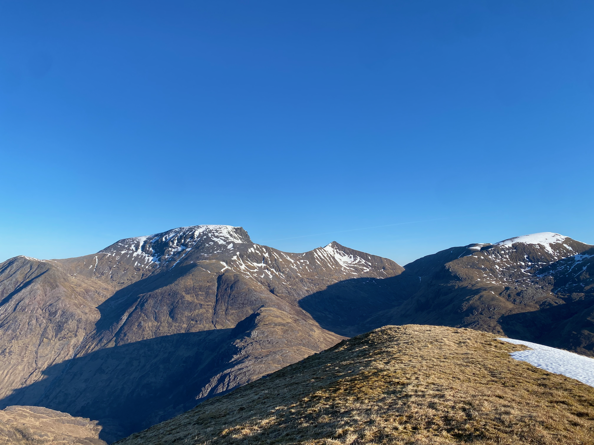 Snow-capped mountains under a clear blue sky.