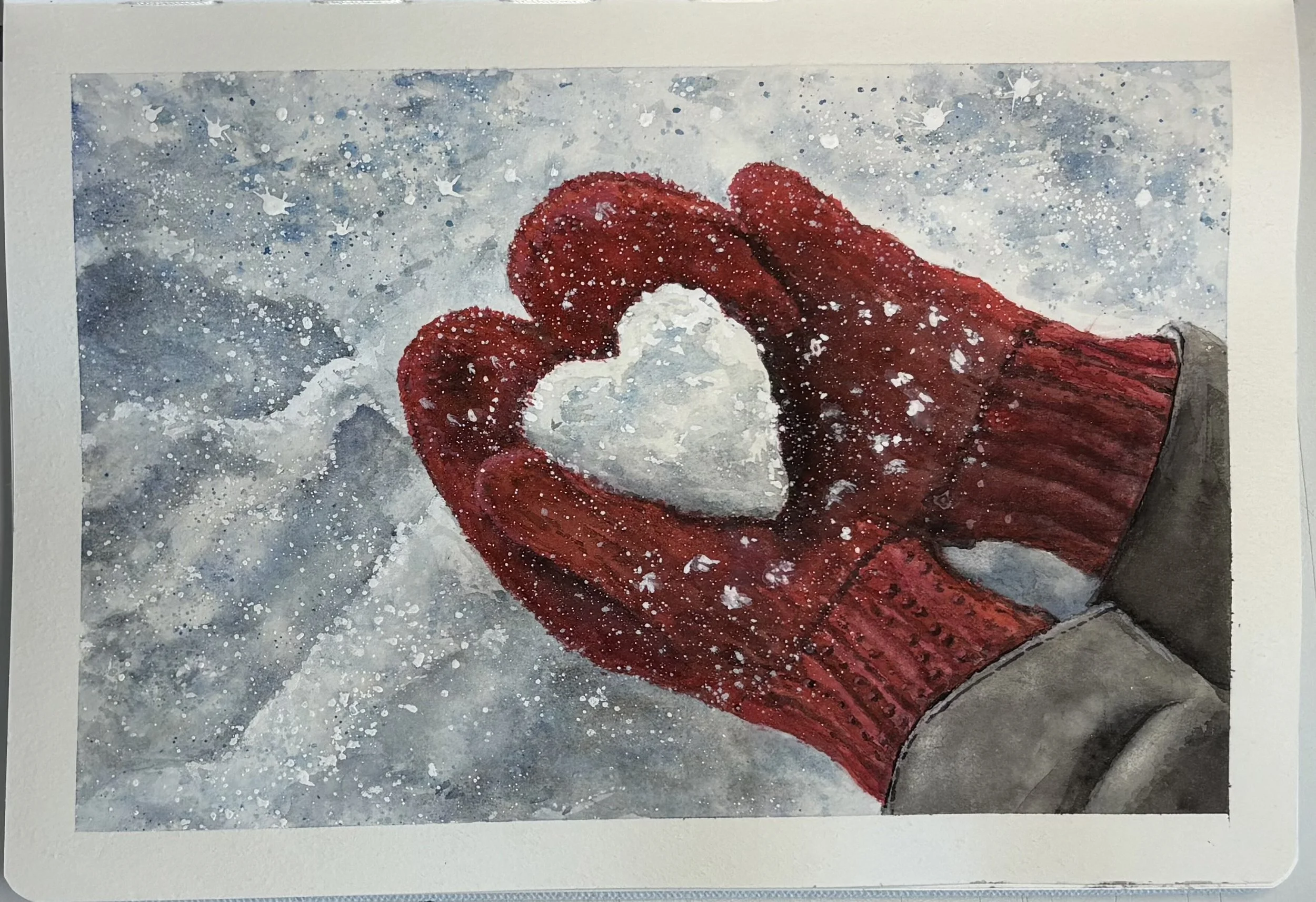 Watercolor painting of red and white mittens, with snow splattered across the background. A realistic snowball resembling a heart in the red mittens. 