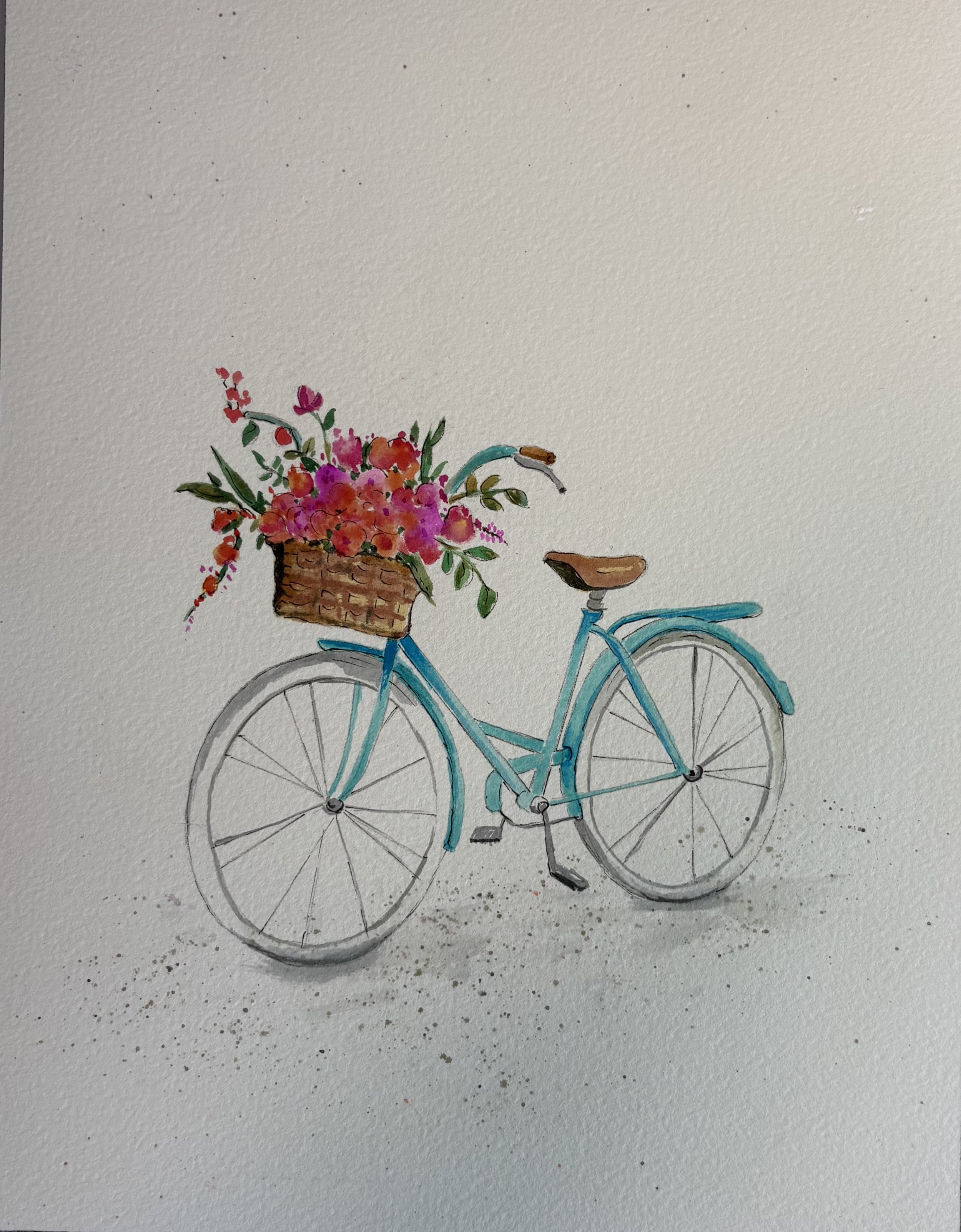 A watercolor painting of a blue bicycle with a basket of flowers, including pink, purple, and red blossoms, attached to the front. Let's Make Art painting in an Etchr journal.