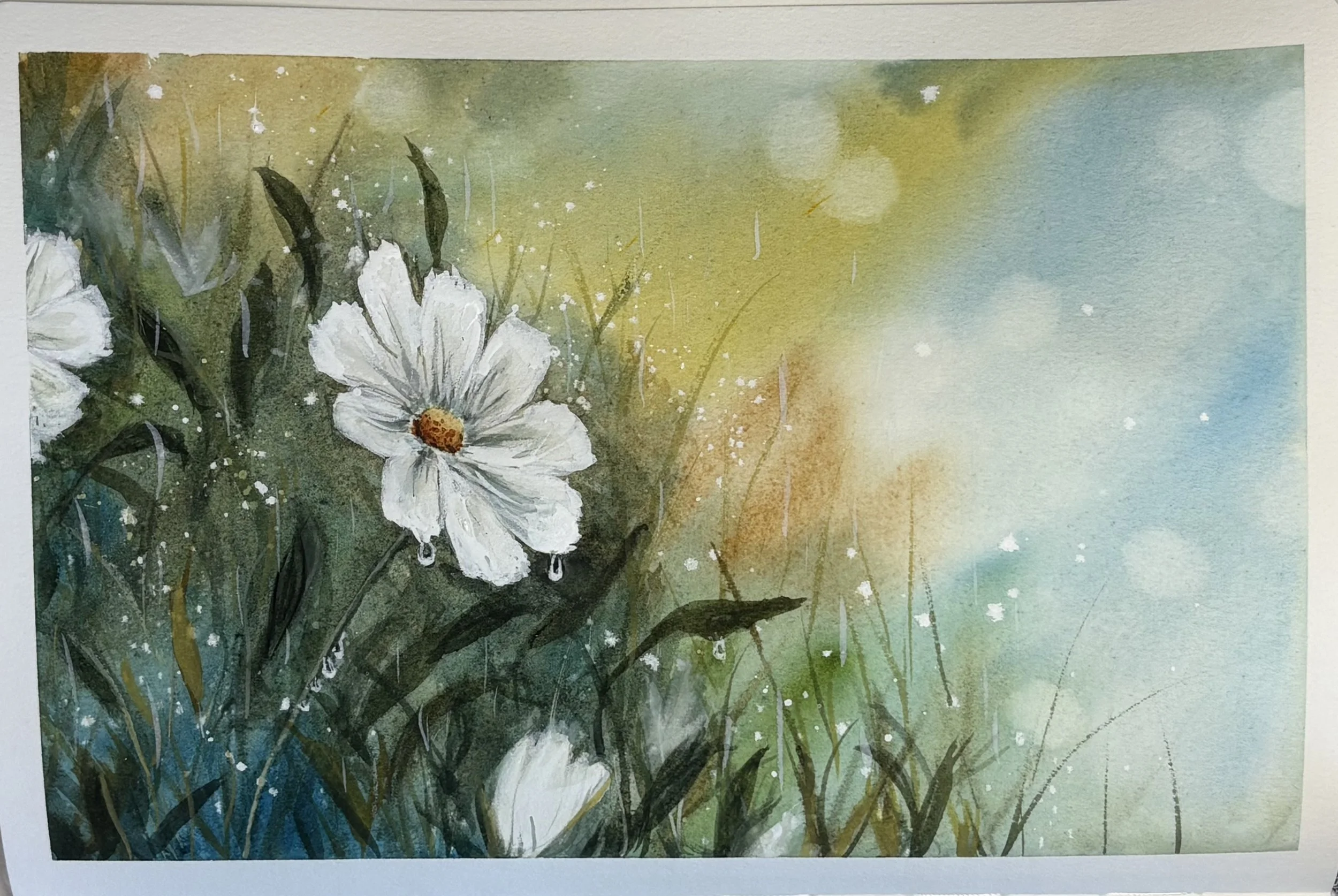 Watercolor painting of white flowers with green stems and leaves, set against a background of yellow, blue, and green hues. The bokeh affect is used in the journal painting.