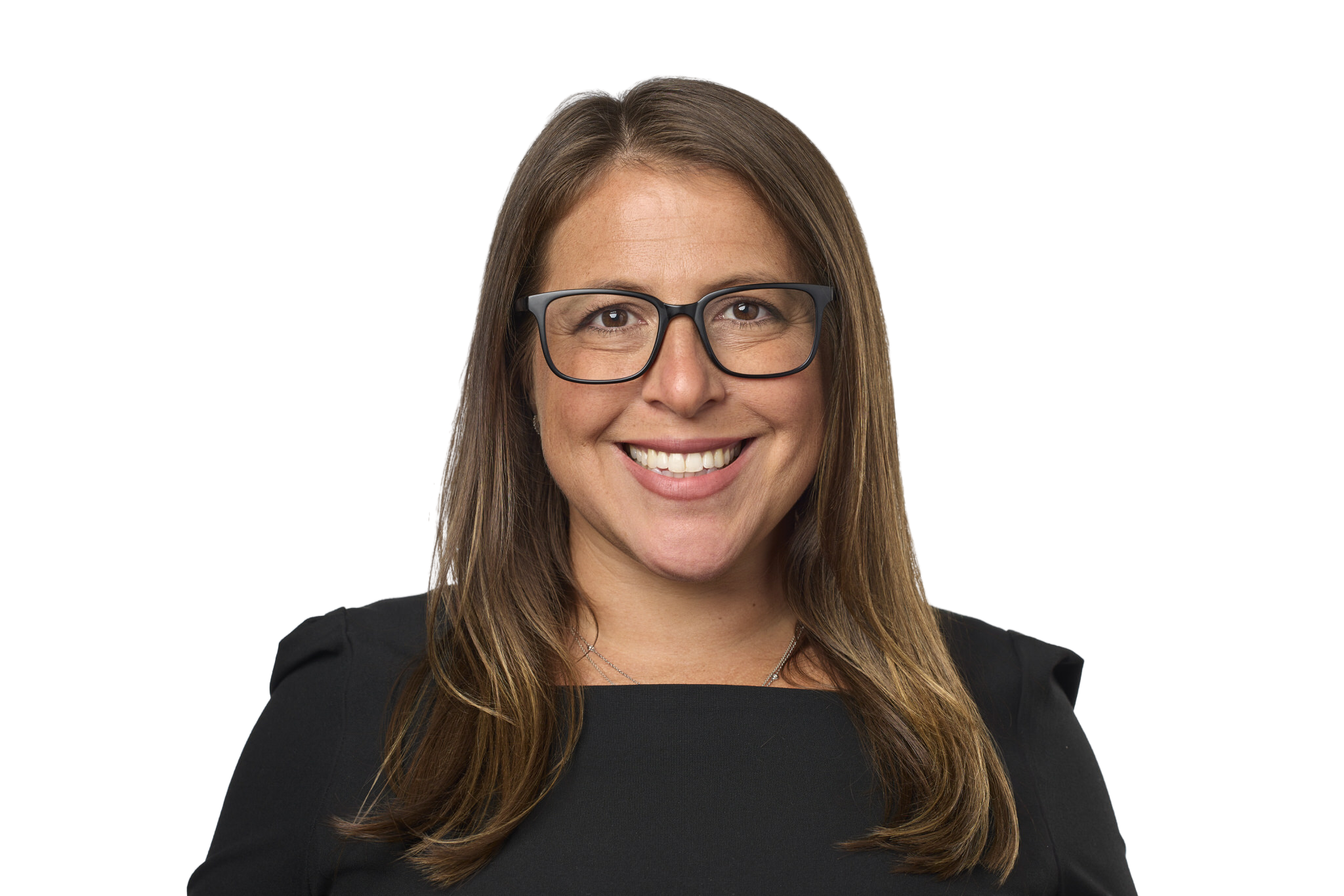 Photograph of a woman with long brown hair, wearing black-rimmed glasses and a black top, smiling.