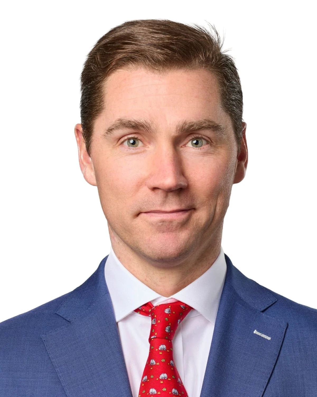 A professional headshot of a man in a blue suit, white shirt, and red tie with a pattern of pandas, set against a plain white background.