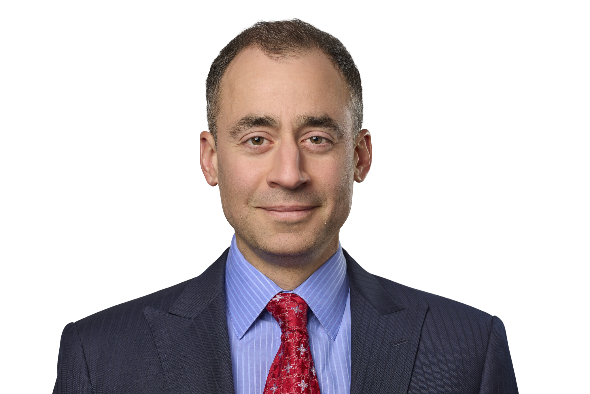 Photograph of a smiling man in a business suit with a blue shirt and red patterned tie.