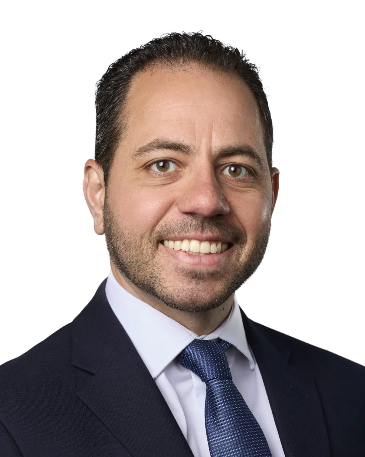 Headshot of a smiling man in a suit and tie.