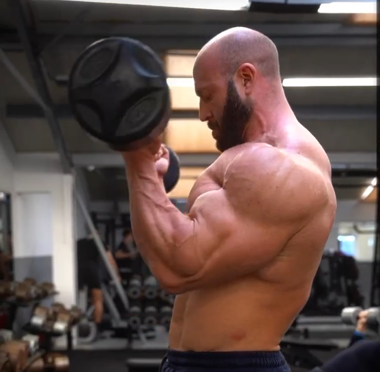 Bodybuilding.com fitness content featuring a weightlifter performing an exercise