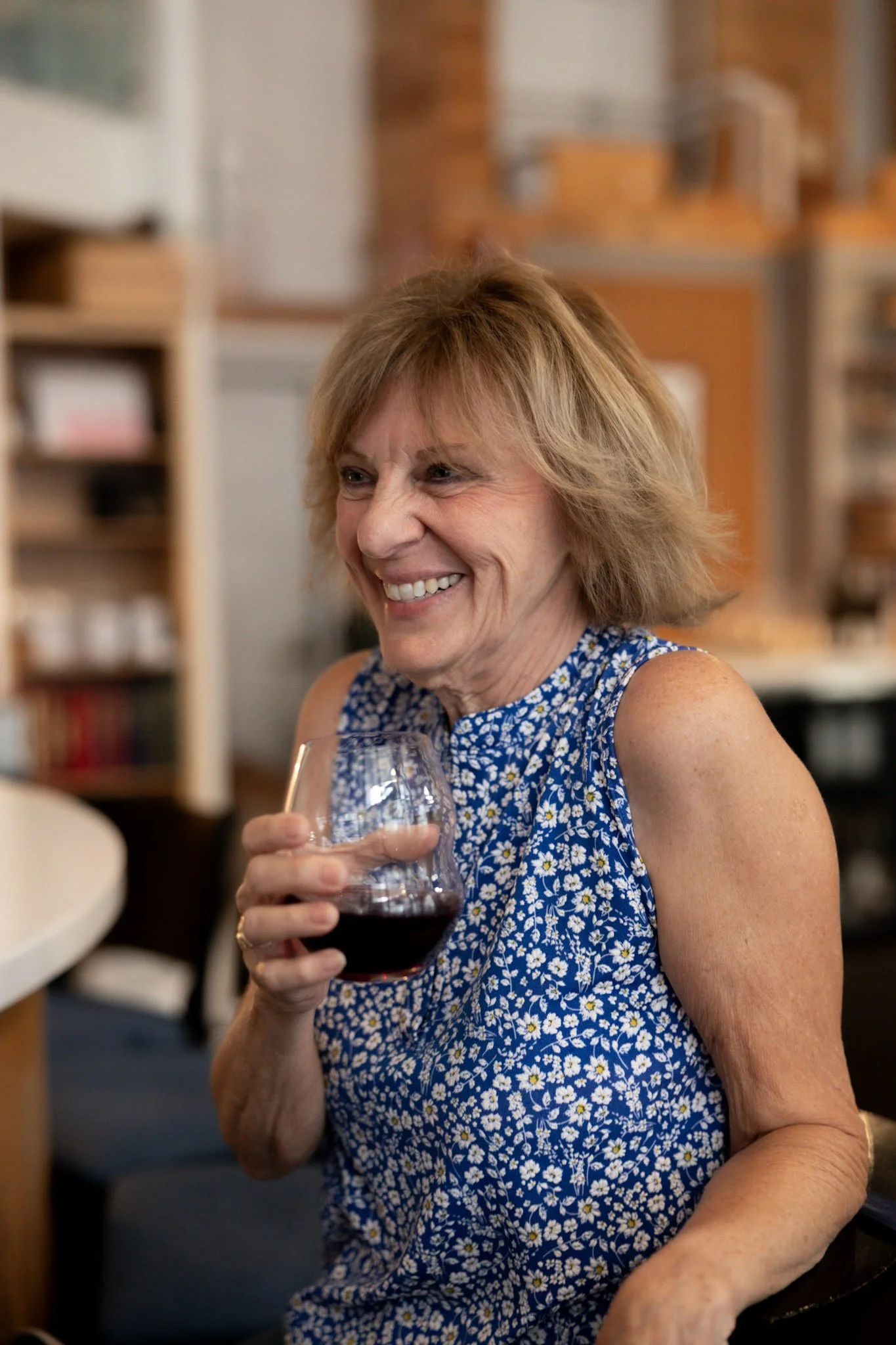 Woman smiling while enjoying a glass of wine at the Sip bar in Bay Harbor, Michigan