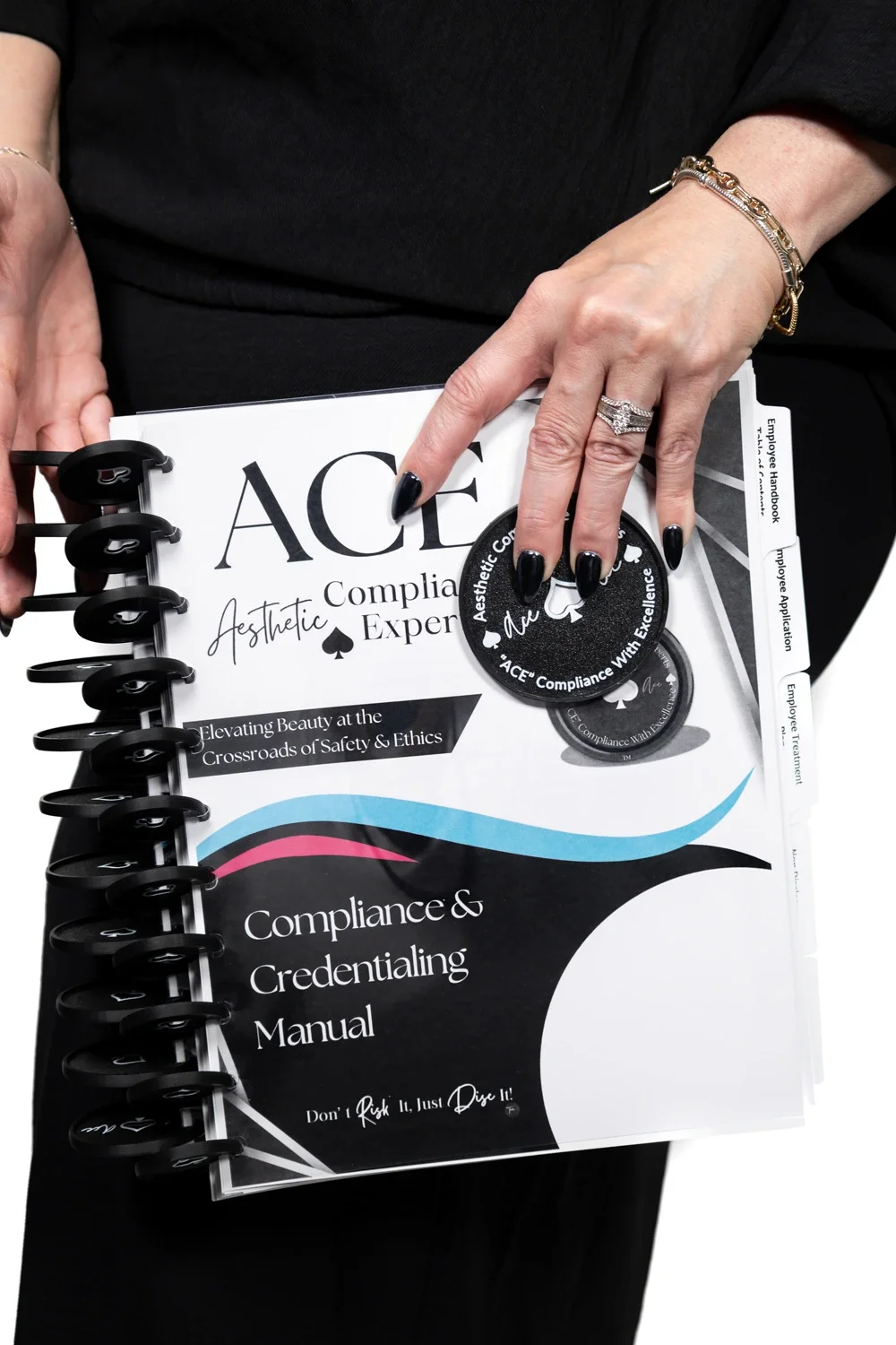 Hands hold a disc-bound “Compliance & Credentialing Manual” with ACE compliance badges.