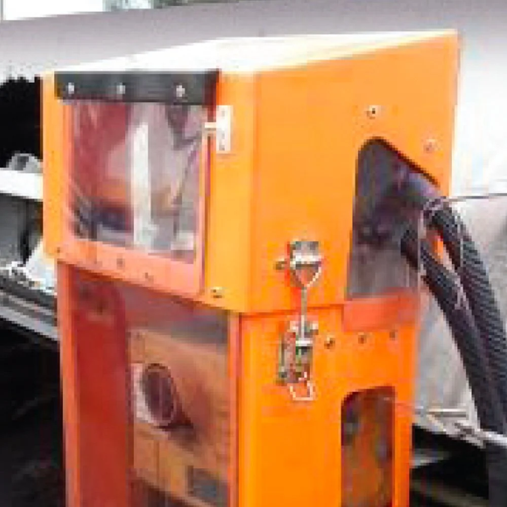 Orange coin-operated vending machine with a transparent window on top and a service panel on the side.