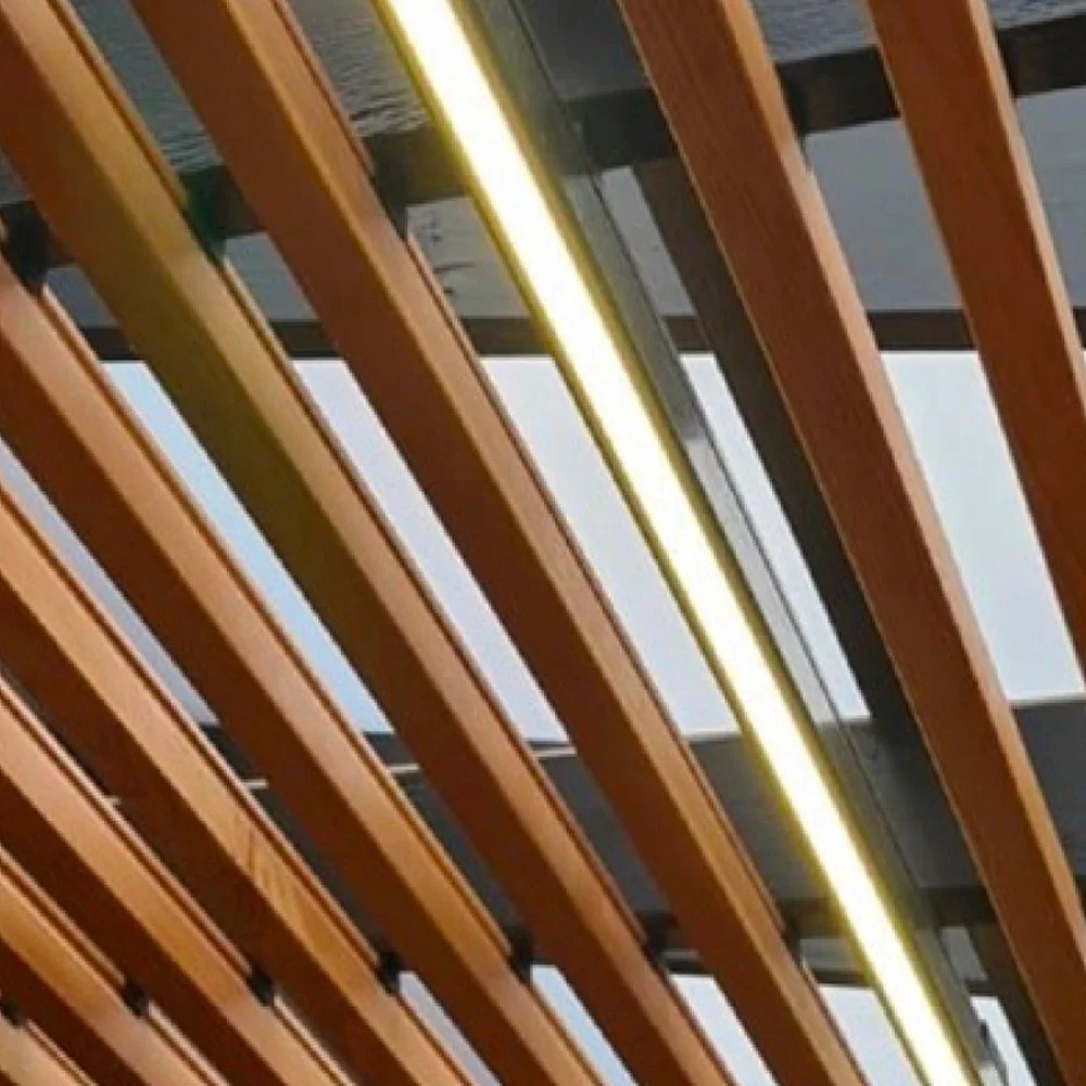Ceiling with wooden slats and a long, narrow light fixture.