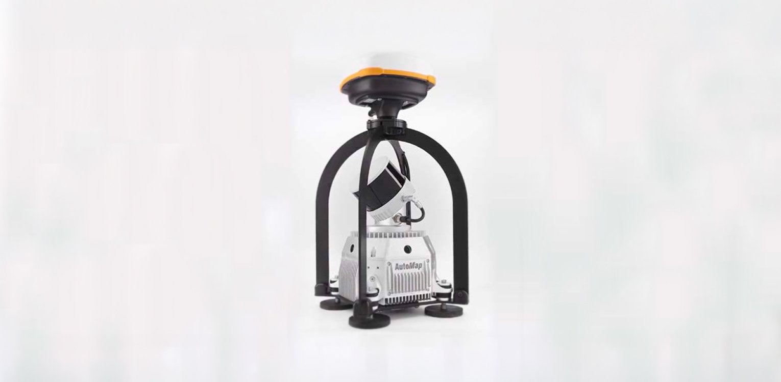 A laser scanner device with a yellow top, mounted on a black frame with four feet, labeled 'AutoMap'.