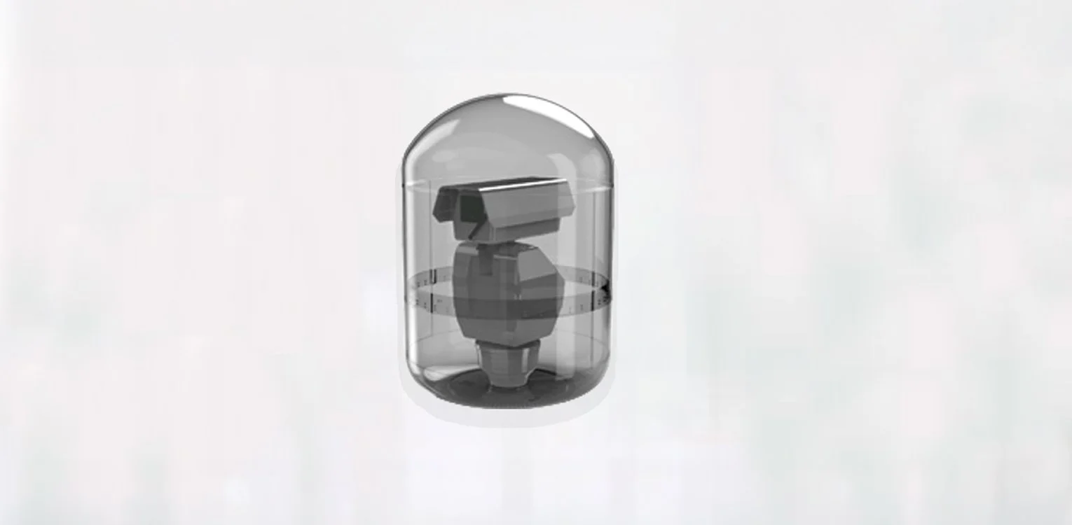 A small robot encased in a clear plastic dome.
