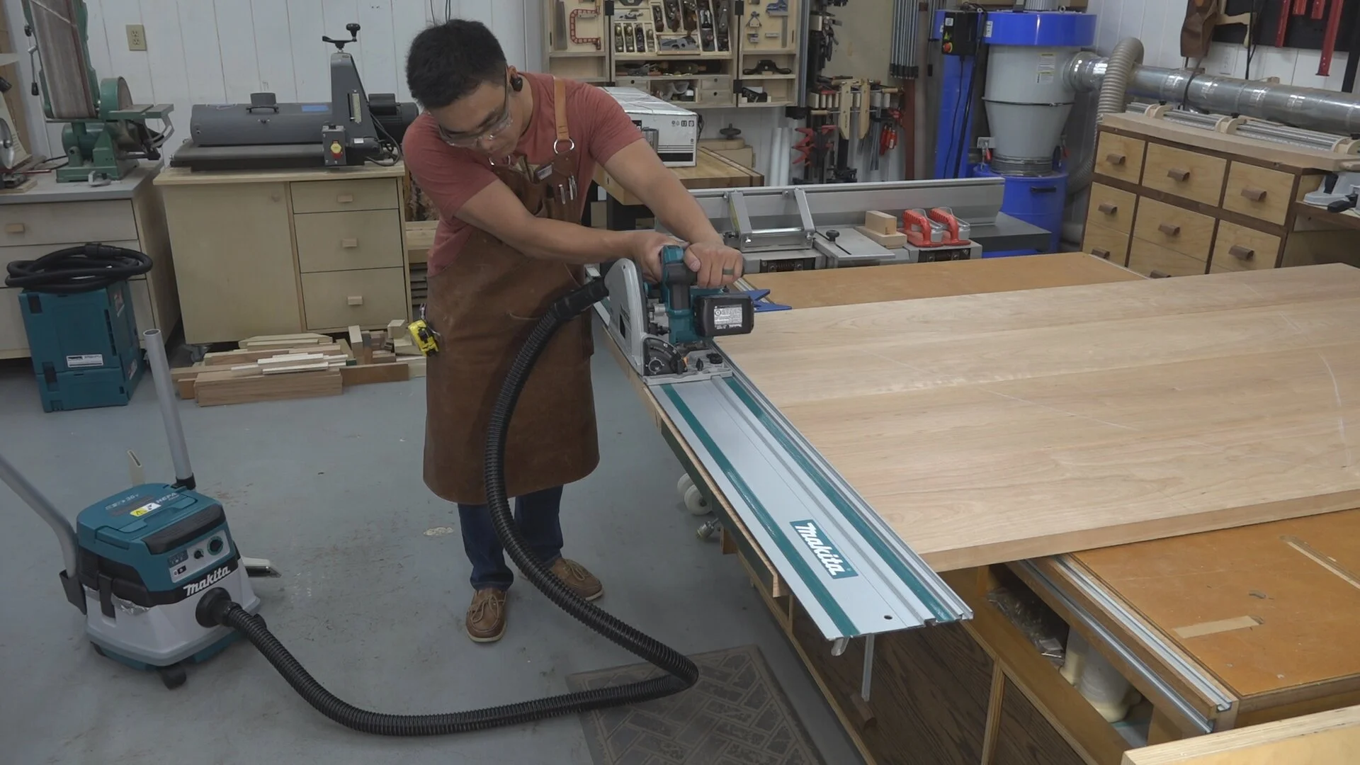 Using the Makita track saw and dust extractor to square up the table top panel