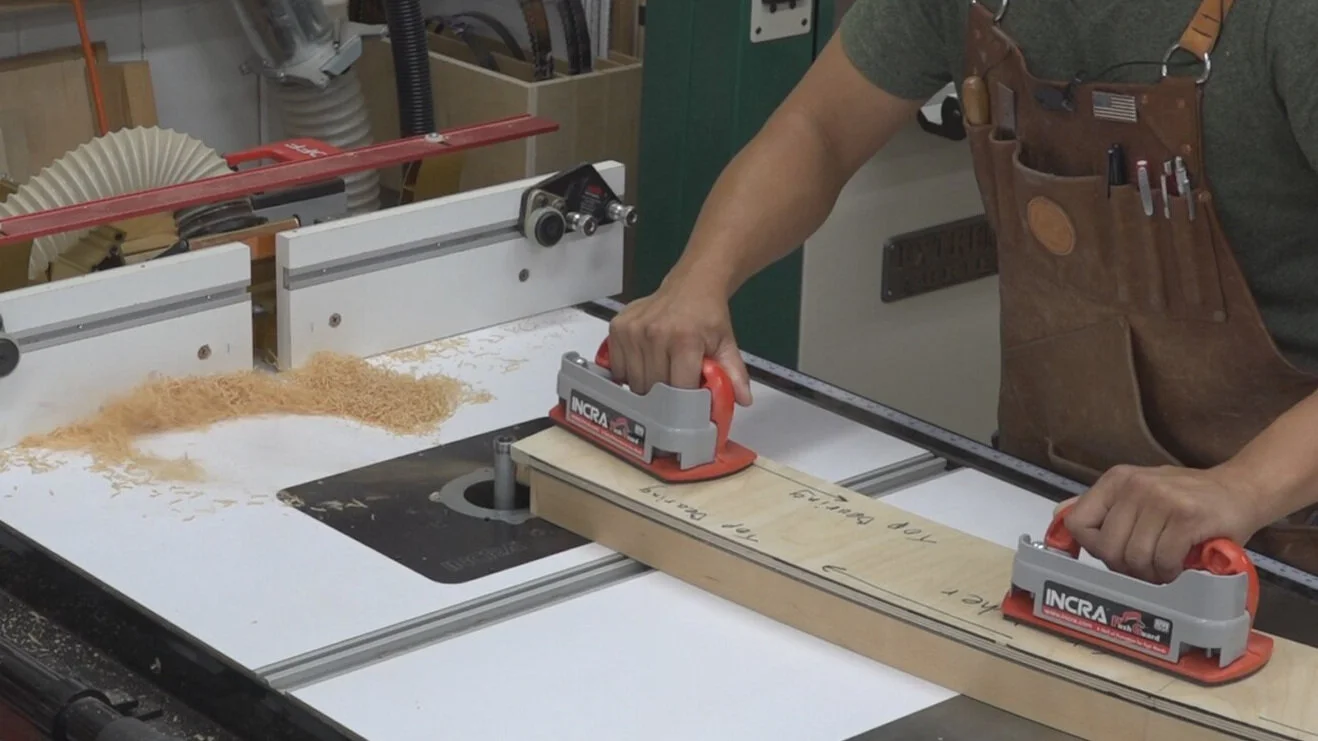 The end of the exposed tenon on the trestle table stretcher hitting the router bit