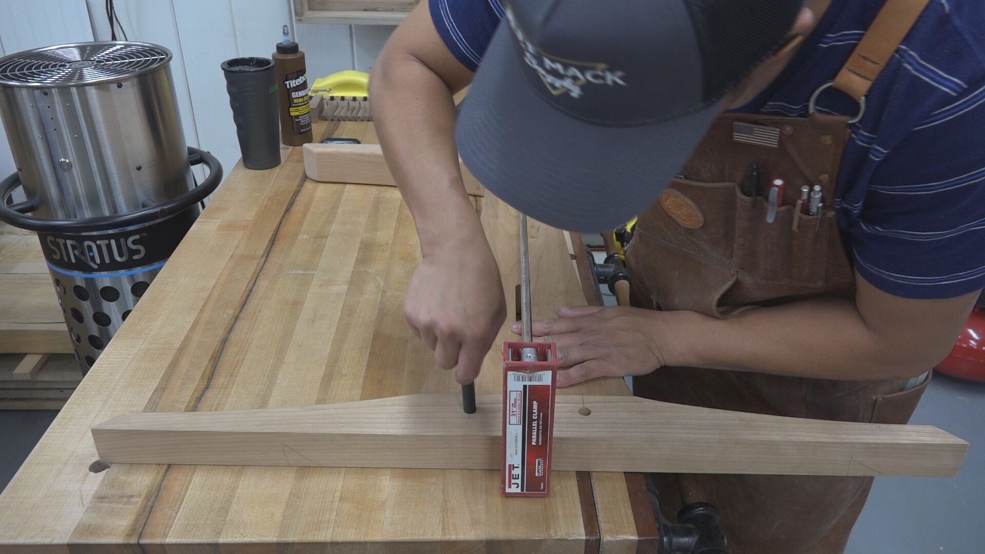 Using a center punch to locate the center of the hole in the mortise