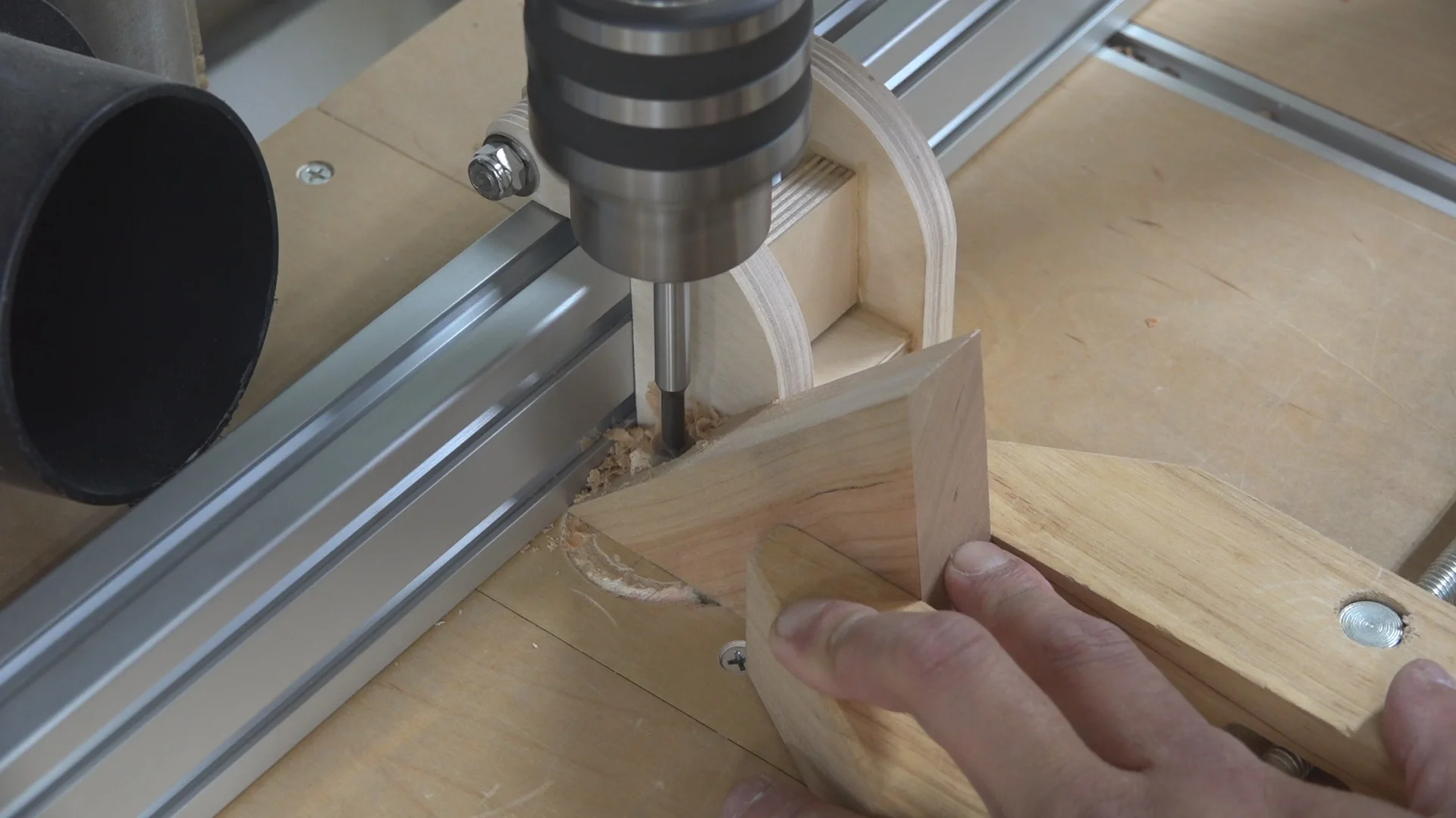 The drill press fence, stop block, and hand screw clamp helps support the work piece while drilling an angled surface.