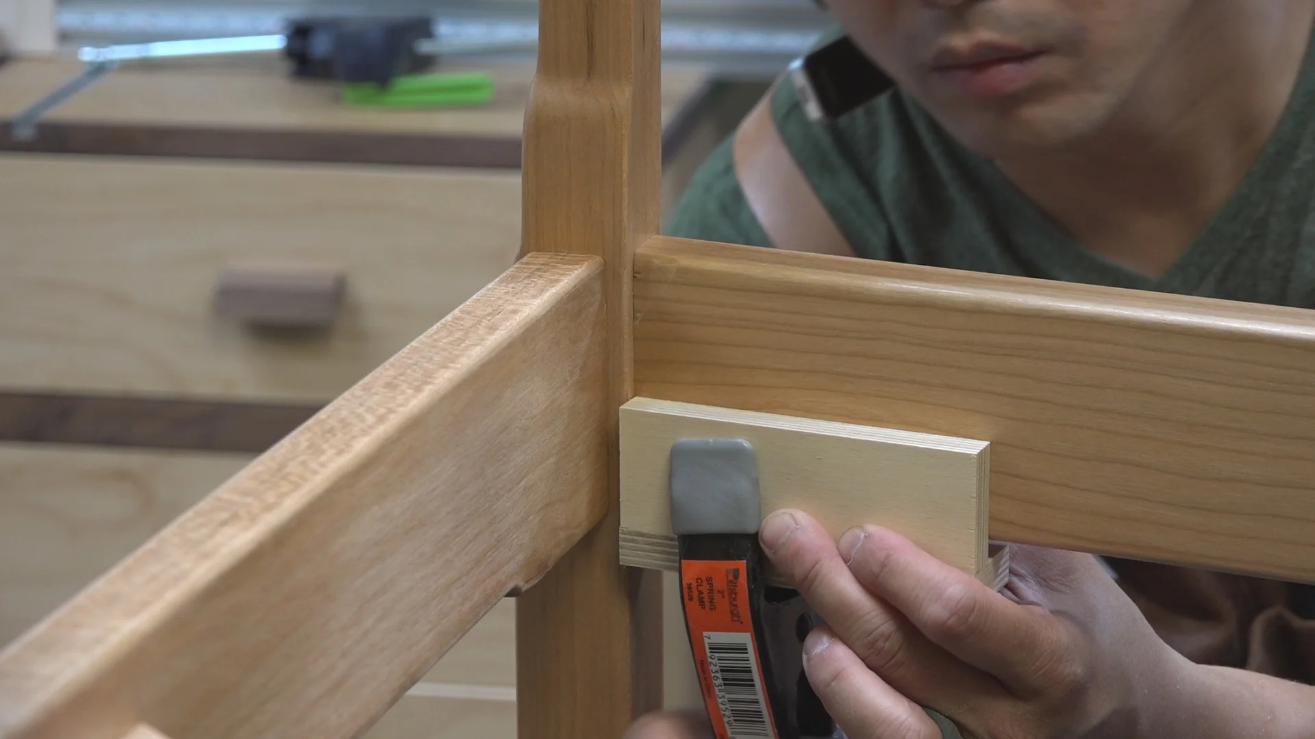 A jig and spring clamp set to the proper height to attach the corner blocks.