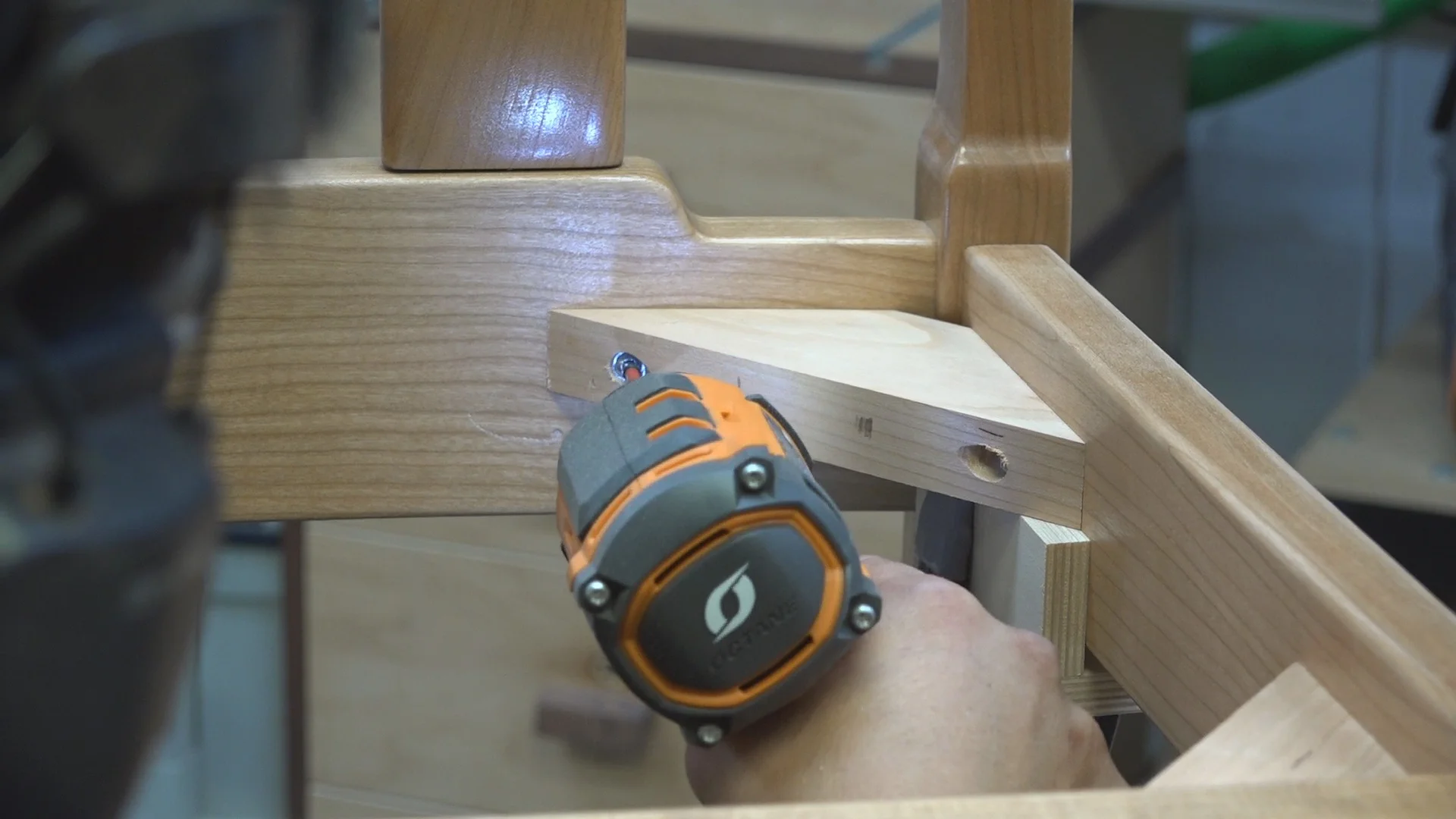 Attaching the back corner blocks. The jig and spring clamp establish the height. I used the Ridgid Octane Hammer Drill/Driver and Impact Driver to set the screws to attach the corner blocks.