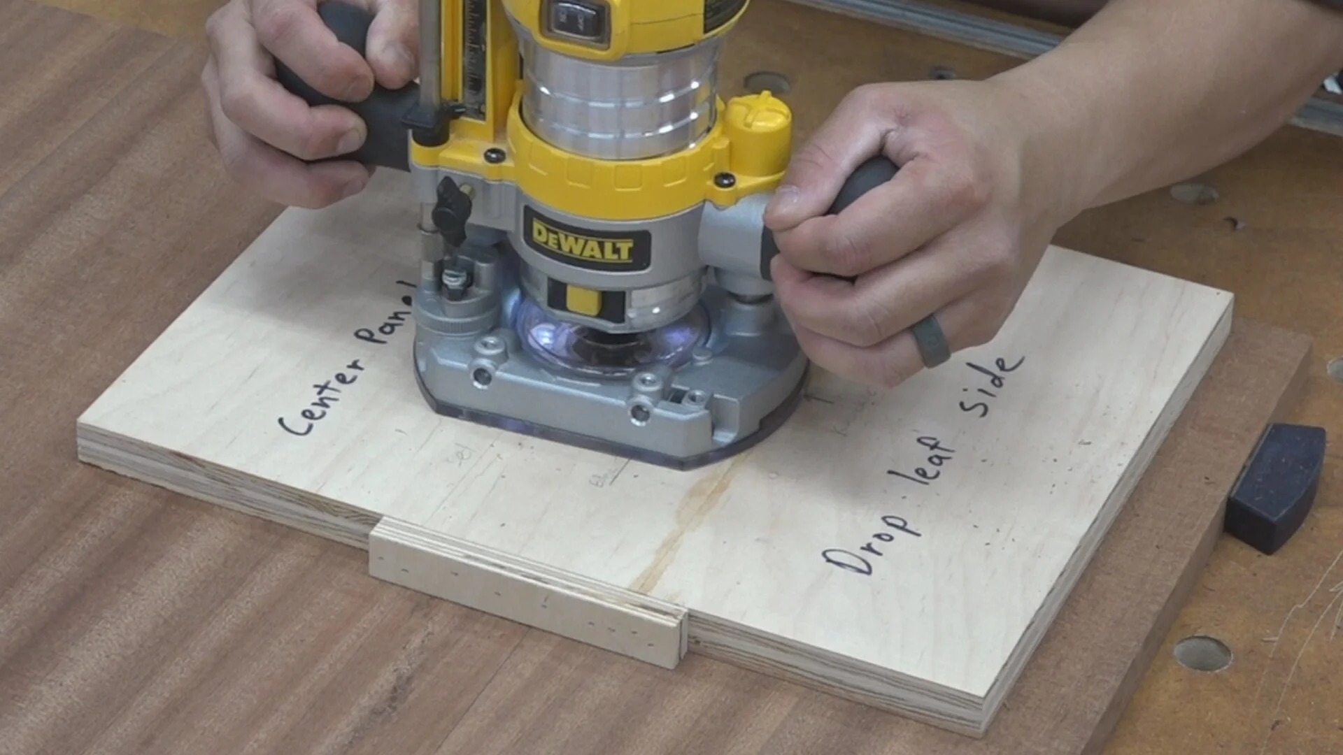 I use a compact router and short flush trim bit to route the hinge mortise leaves.