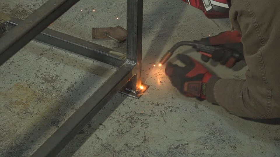 After the end caps are threaded and tapped, they were welded to bottom of the legs.