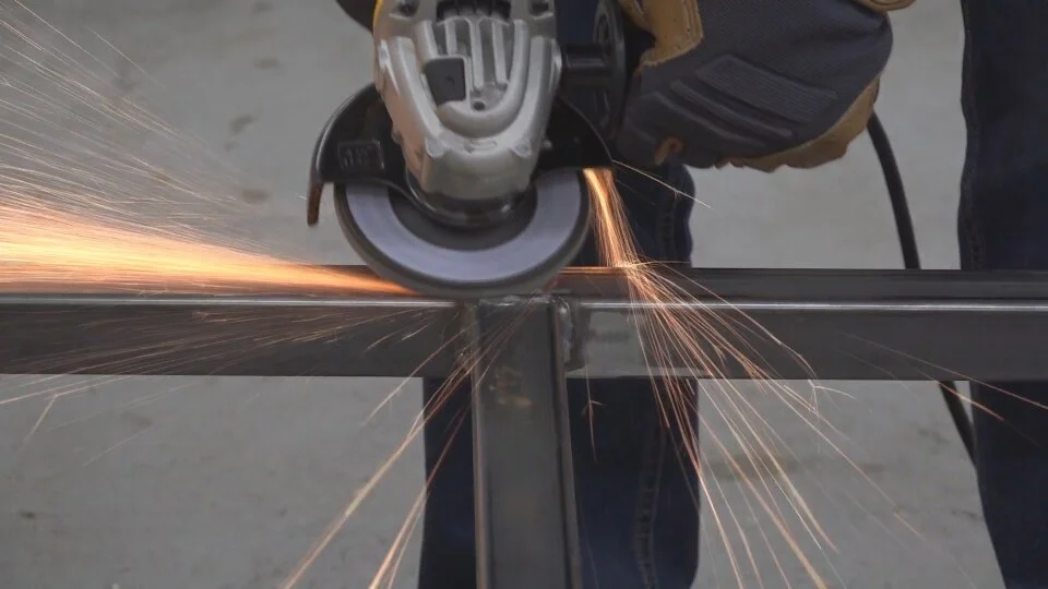 After the welding was complete, I used an 80-grit flap wheel on my angle grinder to clean up the welds.